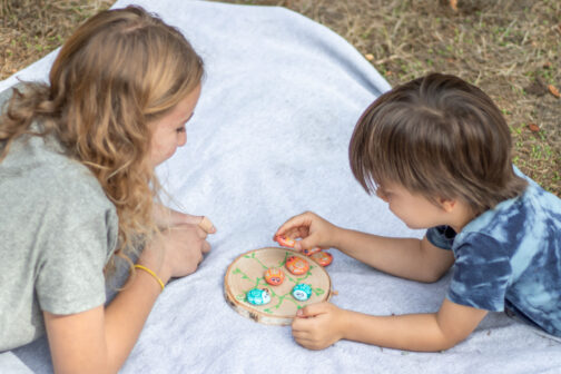 kids playing bug tic tac toe painted rocks epoxy ladybug lovebug bumblebee bee wood round picnic